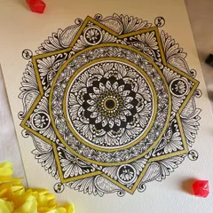 Another view of my geometric star mandala. The contrast between the intricate black and white patterns and the bold gold lines is what I love most about this piece.