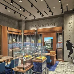 Every detail in the Panerai store is meticulously executed to embody the brand's adventurous spirit. A subtle diver's silhouette graphic on the wall and displays on blue marble pedestals reinforce the nautical theme, while the layout invites exploration of the watch collections.