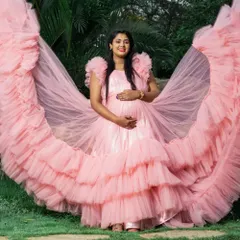The full splendor of our pink ruffled maternity gown. The expansive trail creates a stunning, angelic effect for your photos.