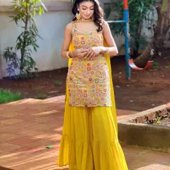 A full-length shot of a vibrant Haldi look in a yellow sharara, created during my airbrush seminar.