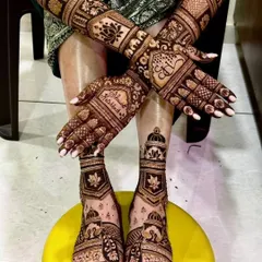 A full bridal mehendi package, showcasing intricate lotus and jharokha designs on the hands with complementary patterns on the feet.