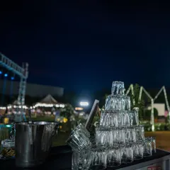 A tower of stacked glasses ready for service at an outdoor evening event. This not only looks impressive but also ensures our bartenders can serve guests quickly and efficiently.