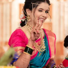 A fun and playful moment! This bride shows her personality while still looking every bit the traditional South Indian queen.