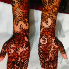 A full view of the hibiscus flower henna on both hands. The design is rich and detailed, perfect for anyone who loves floral patterns.