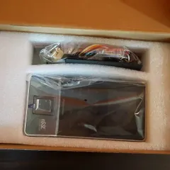 A new eSSL biometric reader, unboxed and ready for installation. You can see the fingerprint scanner and the wiring harness.