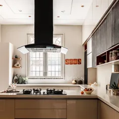 A modern kitchen should be both beautiful and highly functional. We designed this space with handle-less cabinetry for a seamless look, a striking black chimney as a focal point, and ample counter space for easy meal preparation.