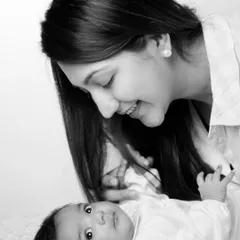 This black and white portrait of a mother and her wide-eyed baby is full of emotion. The simplicity of monochrome puts all the focus on their interaction and connection.