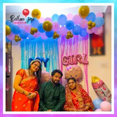 A picture of pure happiness. This lovely family poses for a photo at their baby shower, surrounded by the pink and blue decorations that add to the joy and anticipation of their new arrival.