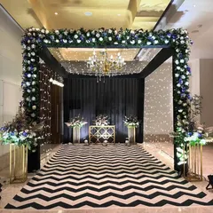 For a chic and modern cocktail night, we designed this stunning entrance. A bold black and white chevron walkway leads into the venue under a canopy of flowers and sparkling lights, setting a glamorous tone for the evening.