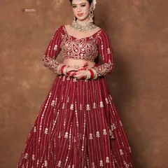 The full bridal look, showcasing how a perfectly executed hairstyle complements the entire ensemble. The neat bun allows the detailed blouse, heavy jewelry, and beautiful lehenga to shine.