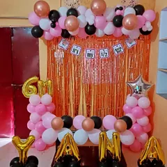 A clear shot of the half-birthday party decoration. All elements, from the balloon colors to the foil letters, are coordinated to create a festive photo corner.