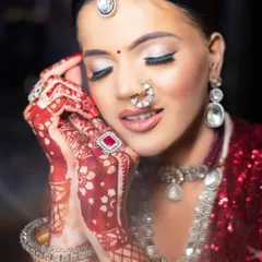 A stunning close-up of the vitiligo bridal look, with eyes closed to showcase the beautiful silver eye makeup and the smooth base.