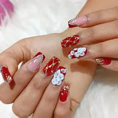Another angle of our popular red bridal nail art, highlighting the dimension of the 3D flowers and the sparkle of the rhinestones.