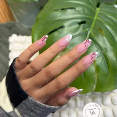 A perfect example of my "not-so-basic" French manicure. This elegant almond-shaped set features a classic white tip, elevated with delicate, hand-painted red bows and a single snowflake accent for a festive touch.