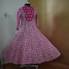 A beautiful Anarkali in a classic pink and white block print. The flared silhouette and high neck design make it a flattering and comfortable choice for any festive gathering.