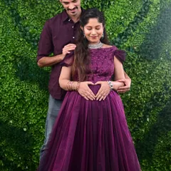 A heartwarming moment captured during a maternity shoot. The couple looks perfect with her in our purple gown and him in a matching shirt.