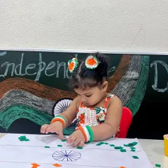 Dressed for the occasion with tricolor accessories, this little girl is engaged in making her own flag. We believe in making learning about our country's history a fun and interactive experience.