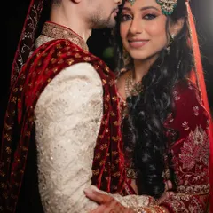 A tender moment from a Nikaah ceremony in Bangalore. The groom's gentle kiss and the bride's serene expression capture the love and solemnity of the occasion.