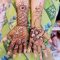 This design features a large peacock on one hand and a floral paisley pattern on the other. The heart motif at the top adds a touch of modern romance.