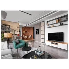 A view across the living room of Apartment 704, highlighting the mix of textures. The design balances minimal furniture with feature elements like the brick wall and a stone-clad bar area.