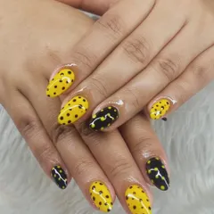 Honey-dipped nails with a little attitude. This honeybee-inspired nail art is the cutest buzz this season, featuring a mix of yellow and black polka dot nails.
