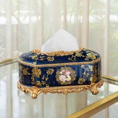Even everyday items can be luxurious. This Victorian-style tissue box holder, in a deep blue with ornate gold detailing and a floral cameo, elevates a simple utility item into a piece of decor.