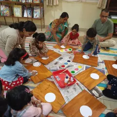 Children and parents work together on a dot painting craft, inspired by the story of "Josephine and her Magic Shoes." Our craft sessions are a great opportunity for family bonding.