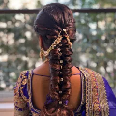 A detailed look at a textured fishtail braid, perfect for a sangeet or mehendi. I wove in a traditional gold accessory to complement the client's royal blue saree, making the whole look cohesive.