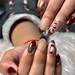 A closer look at the details on these custom wedding nails. Notice the delicate rhinestone placement along the cuticle and the fine lines of the bridal illustration, showcasing our commitment to precision.