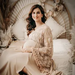 A smiling portrait from one of our boho-themed setups. The rattan headboard, pampas grass, and warm tones create a relaxed, earthy, and stylish atmosphere.