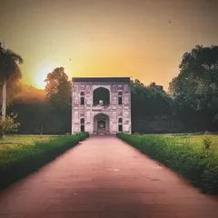 A view of a subsidiary tomb within the Humayun's Tomb complex at sunset. The entire area is a necropolis, with many smaller tombs of Mughal nobility scattered throughout the gardens.