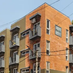 The facade of the Pixel 2 apartment building is a nod to Bengaluru's identity. We used locally sourced red bricks reminiscent of colonial architecture and a textured green plaster inspired by the "Garden City" tag. Each unit features a balcony with grills inspired by old bungalow gates, blending nostalgia with modern design.