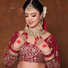 A moment of quiet beauty. The soft, romantic makeup with a classic red lip is perfectly balanced by the traditional hair and jewelry, creating a look that is both stunning and heartfelt.