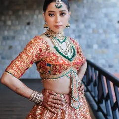 A powerful portrait of a bride in a regal Rimple & Harpreet lehenga, her pose exuding confidence and grace.