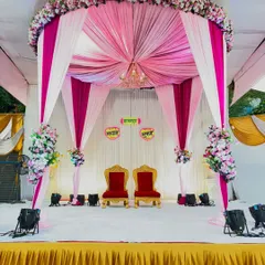 A beautiful canopy-style mandap for an engagement ceremony. I used pink and white drapes to create a royal tent effect, complete with a chandelier and floral arrangements.