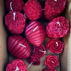 A custom gift box filled with an assortment of my red candles, including rose pillars, ball candles, and floating roses. I can create a similar curated set for you.