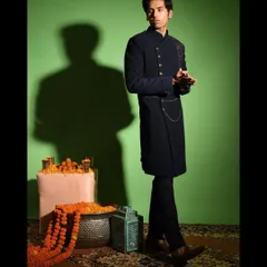 A full length look at the asymmetric Indo western outfit. Paired with tailored trousers, this ensemble is perfect for a cocktail party, reception, or any event where you want to make a contemporary style statement.