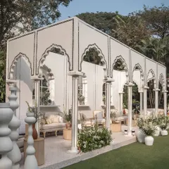 The 'Oasis of Love' featured a stunning pavilion with Mughal-inspired arches and pillars, creating a sophisticated and architectural seating area for guests.