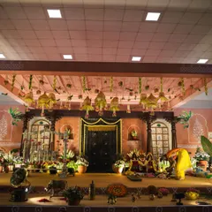 We designed this elaborate stage for little Mitharv's naming ceremony, creating a "South Indian village" theme. The decor featured a traditional door, terracotta tones, and vintage elements to bring the nostalgic concept to life.