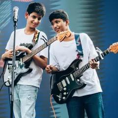 The joy of playing together! These two guitar students are captured sharing a moment during their band performance at the Art Mumbai festival. Learning to communicate on stage is a key part of our band coaching.