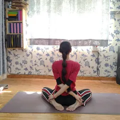 This is Baddha Konasana (Bound Angle Pose) with a posterior arm bind. This variation not only opens the hips but also stretches the shoulders and chest, preparing the body for deeper meditative postures.