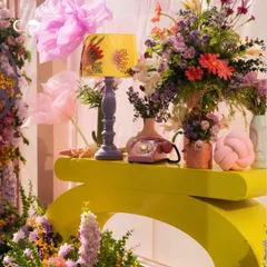 Color, texture, and playful design come together in this detail shot from a Moroccan-inspired party. The sculptural yellow console, vintage phone, and vibrant floral arrangement highlight my ability to style bold and unforgettable events.