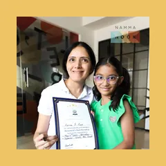 A proud moment with a young participant holding her certificate after a math workshop. Celebrating achievements, big and small, is key to building a child's confidence.