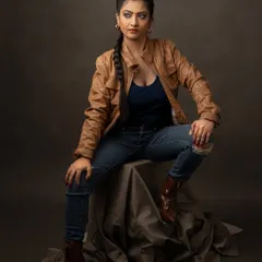 This look is all about grit and attitude. The leather jacket, ripped jeans, and intense expression create a tough, edgy character, adding another layer of range to her actor portfolio.