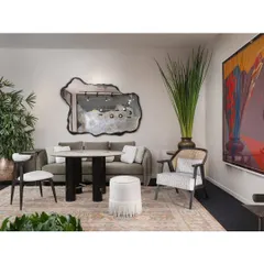 A seating arrangement within the India Art Fair VIP Lounge. We paired a comfortable sofa with our Koko dining chairs and a sculptural mirror to create a space that was both elegant and inviting for guests to relax and converse.