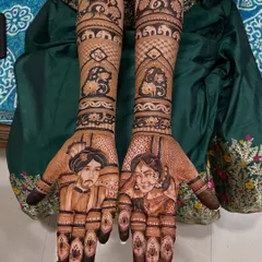 A close-up of a personalized bridal portrait. We capture the likeness of the bride and groom, ensuring every detail from their wedding attire to their expressions is perfectly drawn in henna.