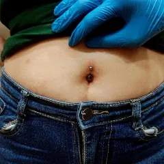Here is a close-up of a navel piercing immediately after it's done, showing my focus on hygiene with sterile tools and gloves. Some initial redness is normal and part of the healing process.