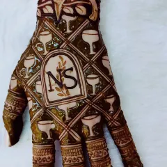 Your mehndi can reflect your personality. This fun design was for a client who loves wine and birds, so I combined them into a unique and personal piece with her initials.