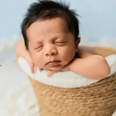 A basket full of love. This pose, with the baby's chin resting on their hands, is a favorite for showing off their adorable, chubby cheeks.