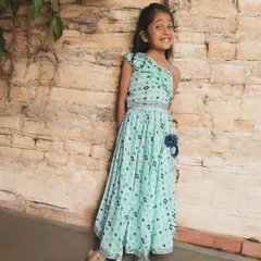 This beautiful one-shoulder dress in a mint green print is all about playful elegance. It's a modern silhouette made with traditional block-printed cotton for a unique look.